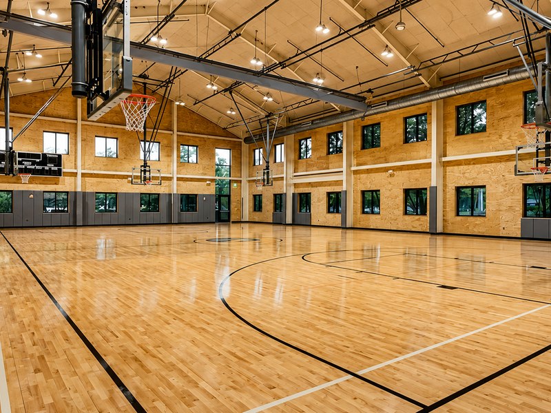 Sunlight across the polished maple floor of R4 Gymnasium